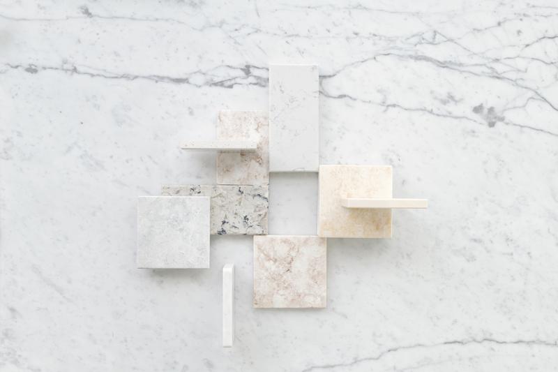 Stone countertop samples laid out on a marble slab