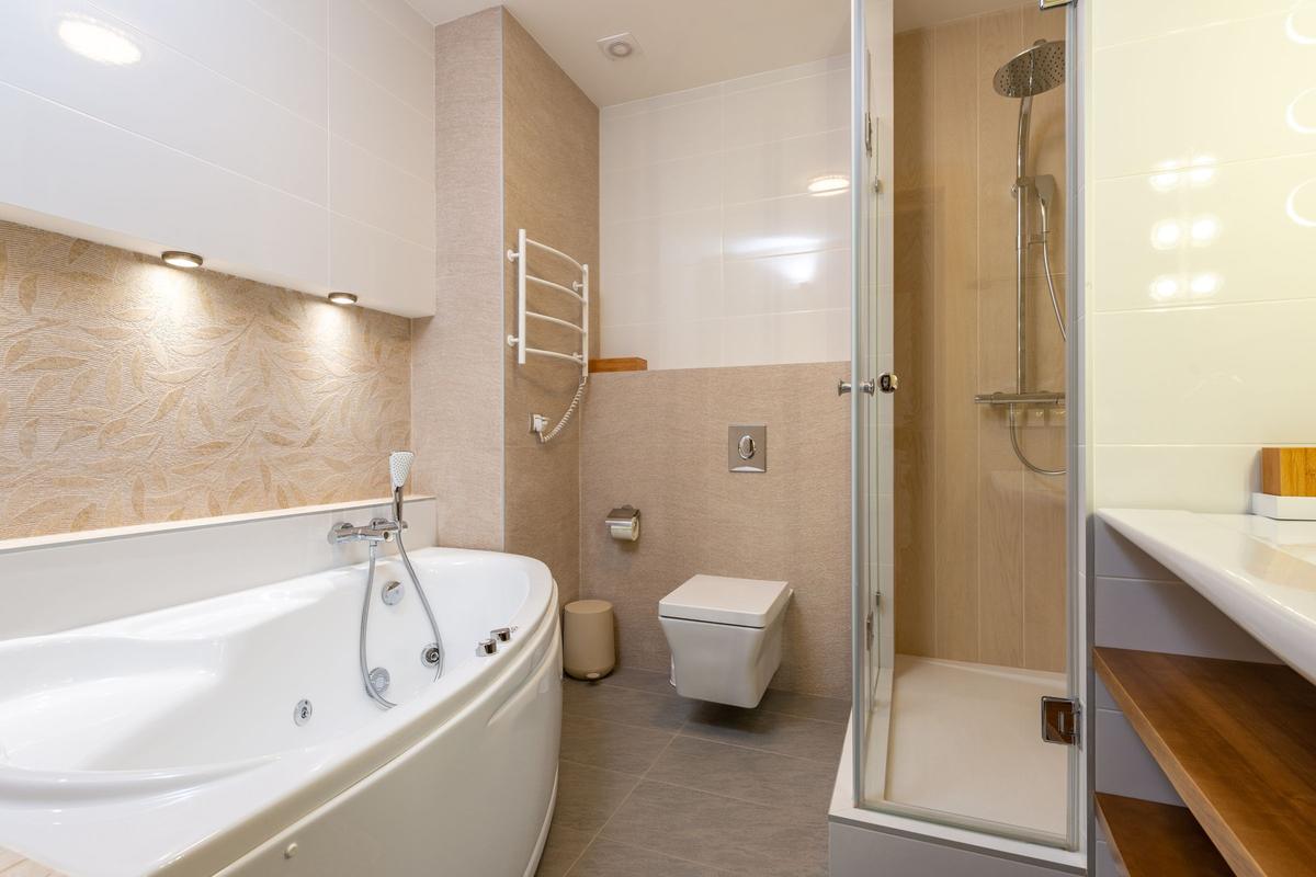 Bright bathroom with a corner tub and a glass shower