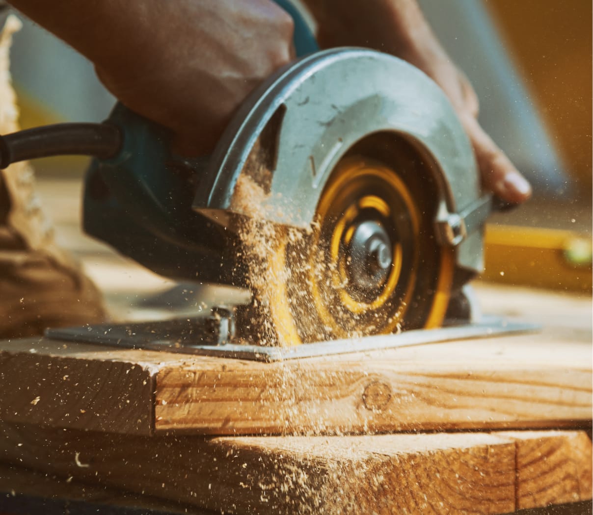 Carpenter cutting lumber with a circular saw