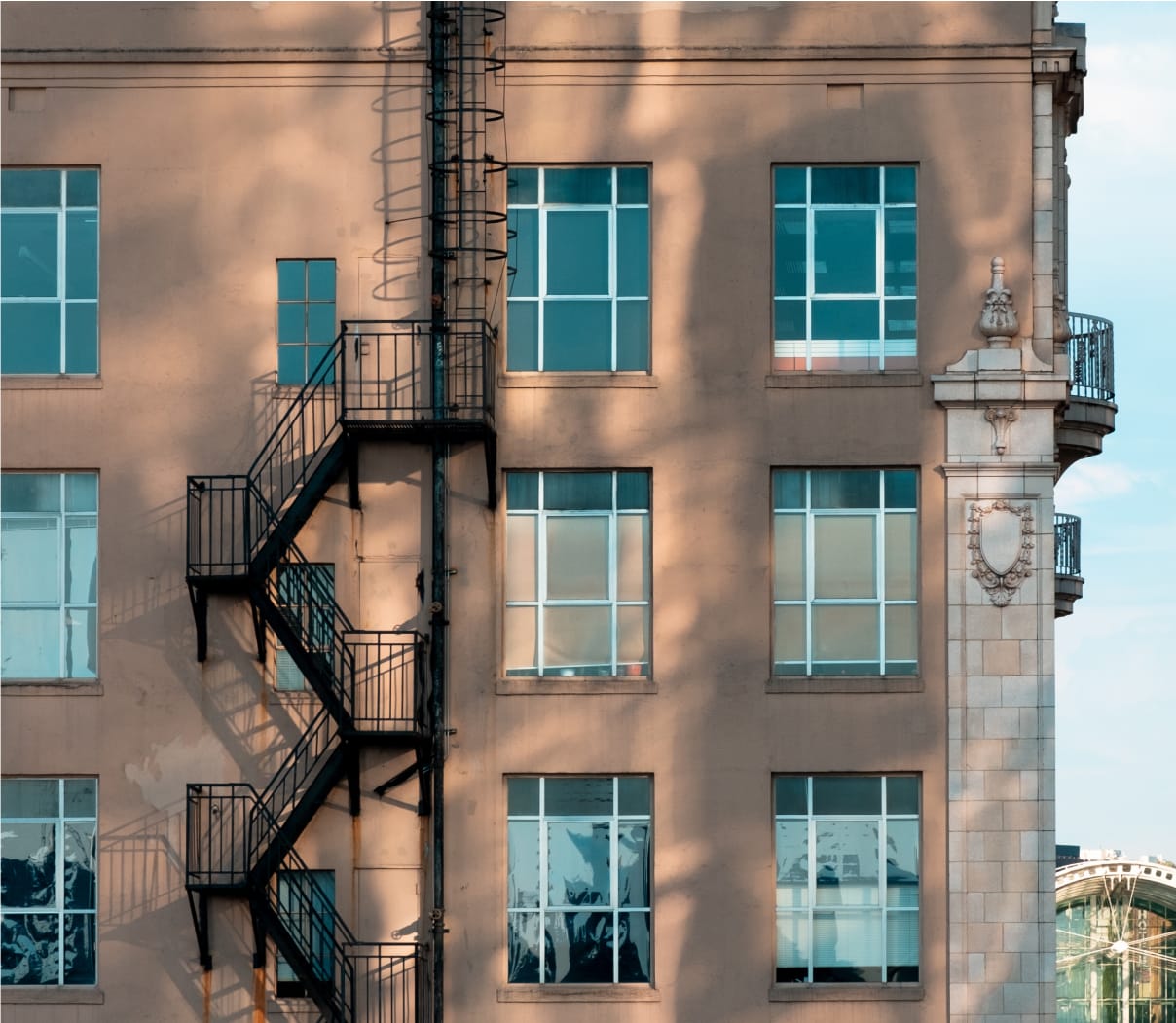 Metal fire escape on the side of a vintage brick building