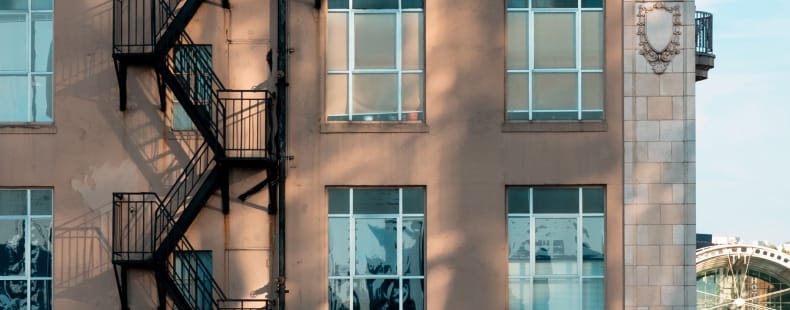 Metal fire escape on the side of a vintage brick building