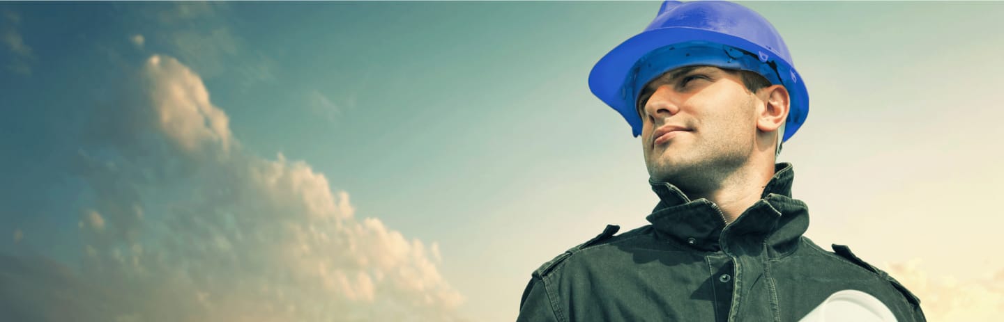 Construction worker with hardhat and blue sky in the background